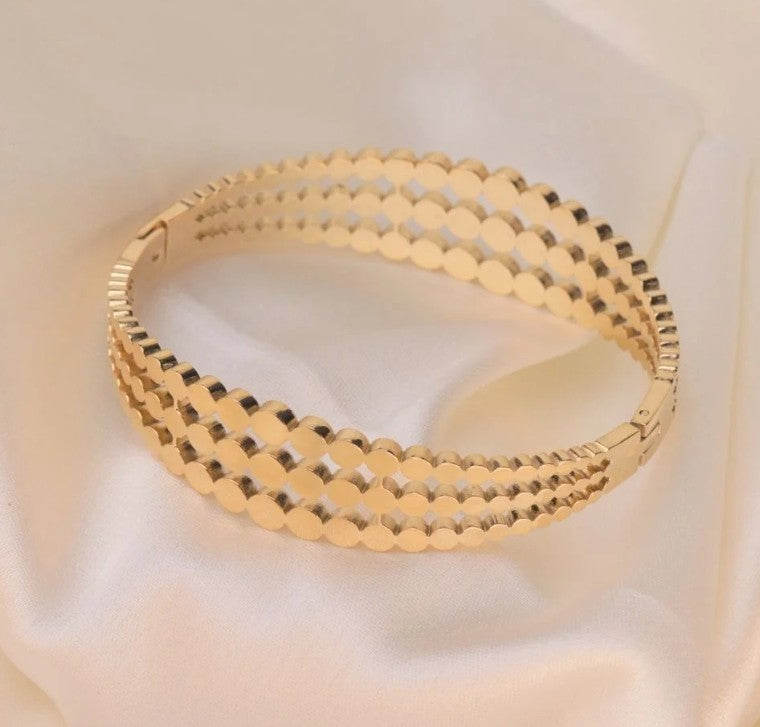 Gold plated Stainless Steel three-layered bangle bracelet featuring a cutout disc pattern