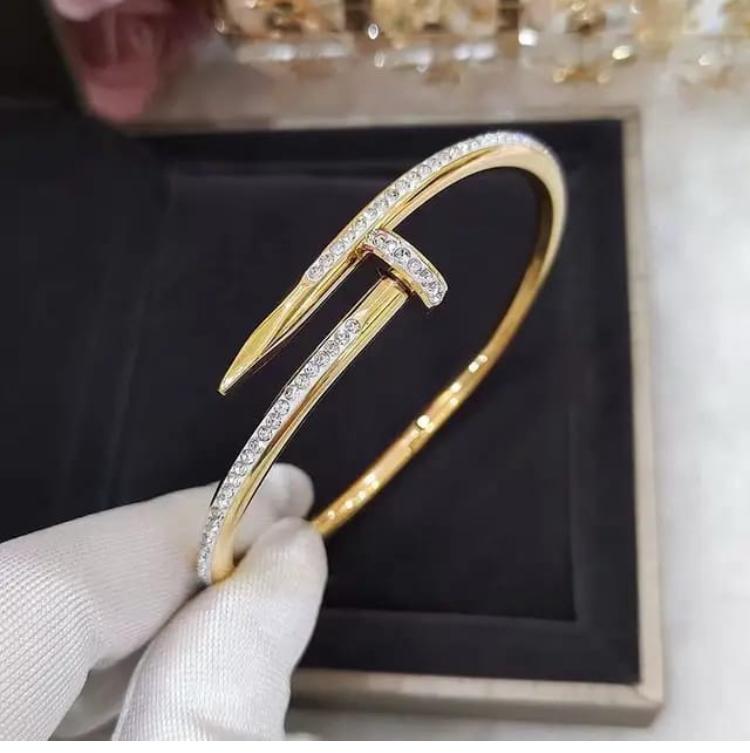 Gold plated stanless steel nail-inspired bangle bracelet with CZ stones