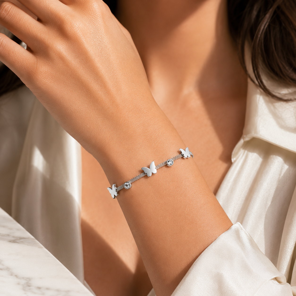 Siliver toned Stainless steel bracelet with butterfly and crystal accents