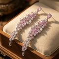 Elegant floral-inspired cascading drop earrings with white & pink cubic zirconia stones.