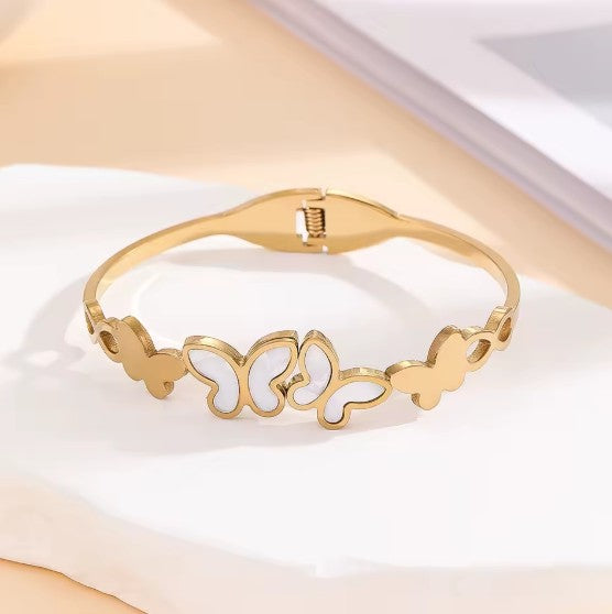 Gold plated Stainless Steel butterfly bangle bracelet with white inlay details.