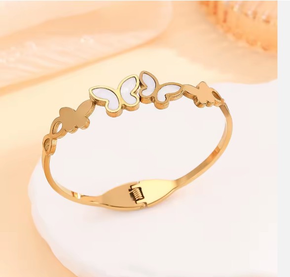 Gold plated Stainless Steel butterfly bangle bracelet with white inlay details.