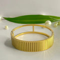 Gold plated Stainless Stell cuff bangle with a textured, linear pattern.