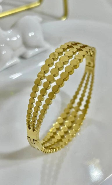 Gold plated Stainless Steel three-layered bangle bracelet featuring a cutout disc pattern