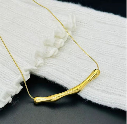 Gold Plated Stainless Steel Tranish-Free Arc Chain Necklace With Irregular Bar Pendant.