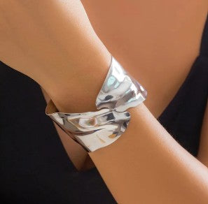Irregular silver-plated cuff bracelet with a molten look.