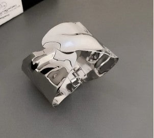 Irregular silver-plated cuff bracelet with a molten look.