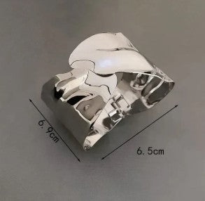 Irregular silver-plated cuff bracelet with a molten look.