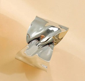 Irregular silver-plated cuff bracelet with a molten look.