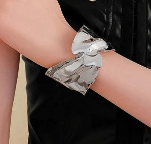 Irregular silver-plated cuff bracelet with a molten look.