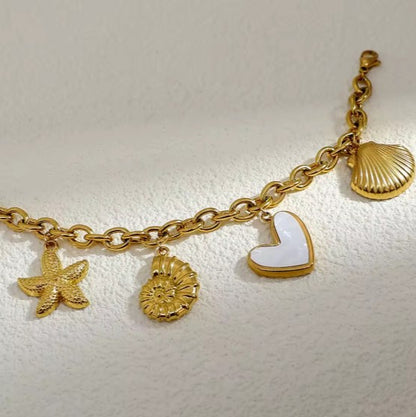 Gold plated Stainless Steel Ocean  bracelet with Starfish, Shell Conch,  and Heart charms on a cuban chain