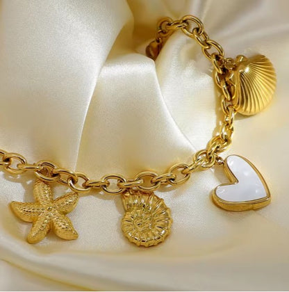 Gold plated Stainless Steel Ocean  bracelet with Starfish, Shell Conch,  and Heart charms on a cuban chain