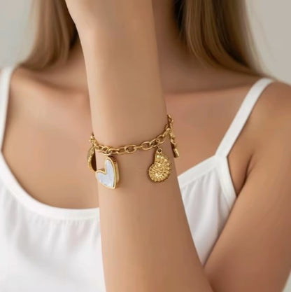 Gold plated Stainless Steel Ocean  bracelet with Starfish, Shell Conch,  and Heart charms on a cuban chain